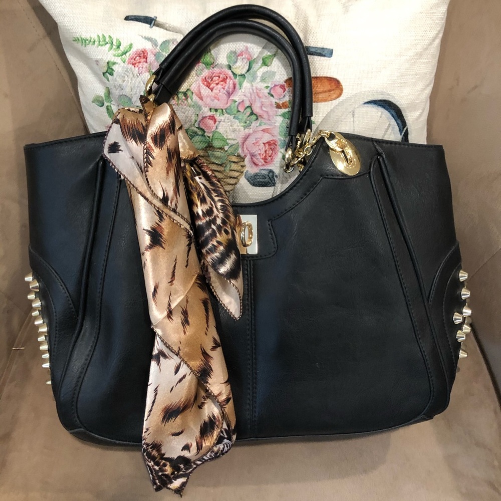 Black shoulder bag with gold spikes